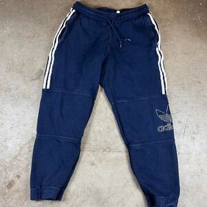 Navy blue Adidas joggers with white stripes and embroidered logo